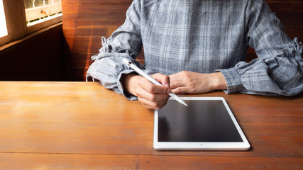 a business women is working on laptop. Financial charts and calculator on the table.
