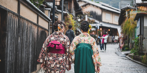 Fototapeta na wymiar Young women wearing traditional Japanese Kimono with colorful maple trees in autumn is famous in autumn color leaves and cherry blossom in spring, Kyoto, Japan.