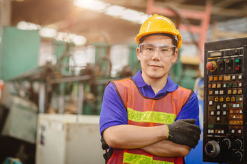 Portrait of smart engineer Asian Chinese happy labor worker handsome model in heavy industry ...