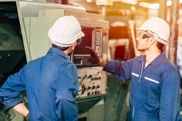 industry engineer team worker teaching help friend operate control heavy machine in factory