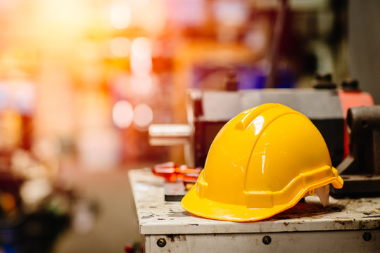 Yellow Helmet Hardhat Safety For Factory Worker Working In Danger Workplace With Space For Text.