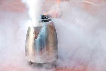 evaporating liquid nitrogen from a metal teapot all in clouds of steam