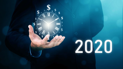 Businessman Without Head Dollar sign clock on hand. Business Concept time is money. Year 2020.