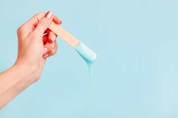depilation and beauty concept - sugar paste or wax honey for hair removing with wooden waxing...