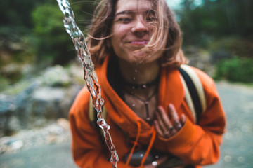 Girl drinks water with his tongue hanging out.