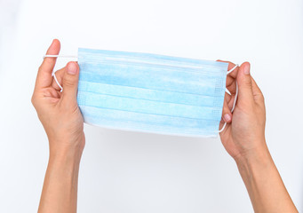 Blue medical disposable face mask with hand.