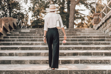 Portrait of a charming girl climbing the stairs to Piazzale Michelangelo in Florence. The concept...