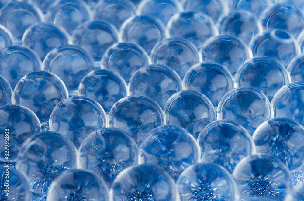 Poster abstract science texture - blue transparent glowing nucleuses in a row on glittering surface as tiss