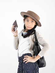 Happy Asian girl wearing flatcap and holding flight ticket and passport, travel concept.