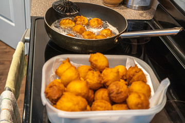Nigerian Buns deep fried in a frying pan