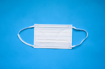 Protective face mask on blue background
