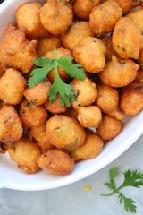 Moong dal ke pakode, ram laddoo, bhajias, Moongode or fritters. served with green mint and coriander chutney. Served over light background. Selective focus. with copy space.
