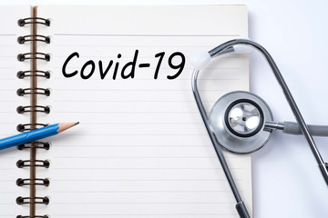 Stethoscope on notebook and pencil with Covid-19 words as medical concept. Stop Novel Coronavirus outbreak covid-19 2019-nCoV symptoms in Wuhan China. Travel or vacantion warning.