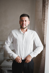 Beautiful man, groom posing and preparing for wedding