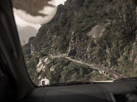 Driving through dangerous mountain roads in the Himalayas