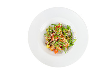 Potatoes with meat, beef, lamb, zucchini, tomato, sesame seeds and green onions, with teriyaki sauce, fried, baked portion on plate, on a wooden board on white background view from above. For the menu