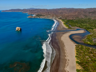 Beautiful aerial view of a sunset in  Naranjo Beach - Witch Rock Costa Rica