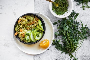 Vegan pasta with pesto, colorful macaroni with vegetables on plate. Mediterranean Italian traditional healthy food on lunch or vegetarian dinner.