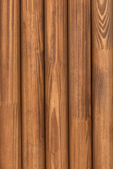 A row of wooden pine round in cross-section of sticks (slats, dowels)