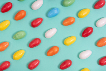 Various coloful Easter eggs on an aqua menthe surface