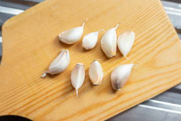 Garlic on a wooden chopping board.