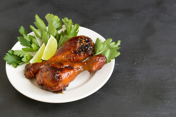 chicken legs fried in sweet and sour sauce with sesame seeds