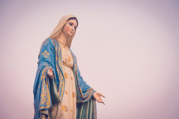 The blessed Virgin Mary statue figure in a sunset time. Catholic praying for our lady - The Virgin...