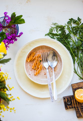 Pasta macaroni food left after lunch, dinner on empty, unclean, dirty plate on table.