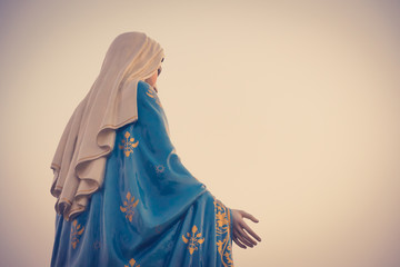 The blessed Virgin Mary statue figure in a sunset time. Catholic praying for our lady - The Virgin...