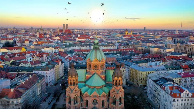 Aerial Munich skyline view from above drone video fly over city old town view of frauenkirche church cathedral town hall and tv tower.
