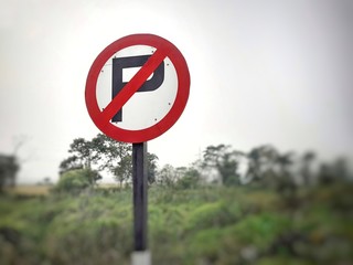 No parking round sign plate at the highway. No parking zone symbol. Do not enter sign on road