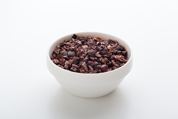 Cacao nibs in white bowl
