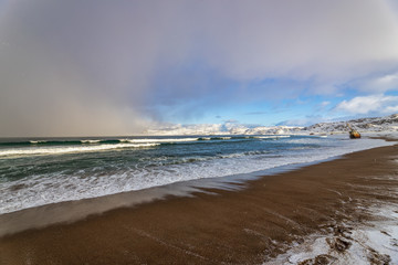 Sudden change of weather. Impending snow storm on the shore of the Barents sea, the Kola Peninsula, Teriberka, Russia