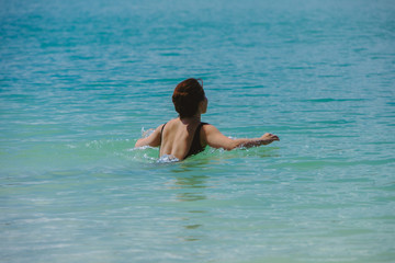 woman swimming in blue clear sea water