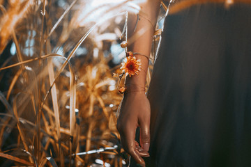 close up of young and tender woman shoulder in setting sun rays of light