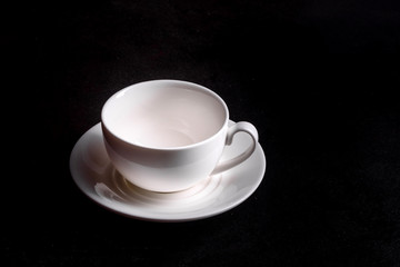 Preparation of aromatic morning coffee. Empty white coffee cup on a dark table
