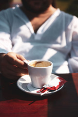 Close up of man hands holding a cup of coffee