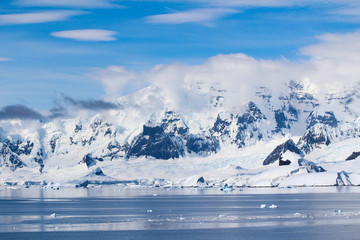 Landscape of snowy mountains and frozen coasts along the Danco Coast in the Antarctic Peninsula, Antarctica