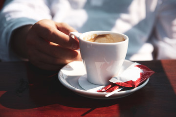 Close up of man hands holding a cup of coffee