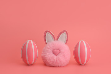 A pink fluffy rabbit bunny pom-pom between two pink striped eggs. Easter concept on a pink background. Monochromatic Easter. Postcard, congratulations, decoration. Copy space.