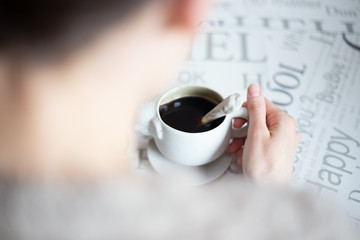 Close up of woman hands holding a cup of coffee