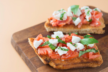 Italian bruschetta with tomatoes, mozzarella cheese and basil