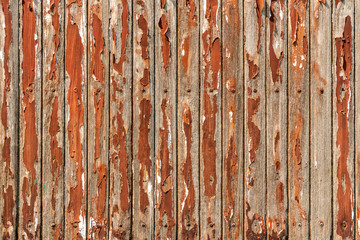 Old red wooden plank pattern on table with grunge and peeled off surface. Abstract background. Vintage and retro backdrop.