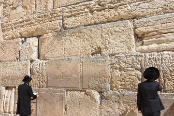 Fototapeta premium Jews in praying at the Wailing Wall in Jerusalem, Israel.