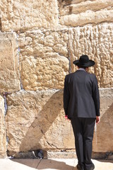 Fototapeta na wymiar Jew in praying at the Wailing Wall in Jerusalem, Israel.