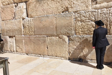 Fototapeta premium Jew in praying at the Wailing Wall in Jerusalem, Israel.