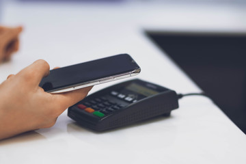 A woman pays for the service using her phone