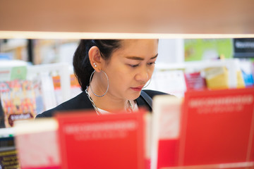 Asian working woman in a book store.