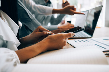 Business people analyzing investment graph meeting brainstorming and discussing plan in meeting room, investment concept