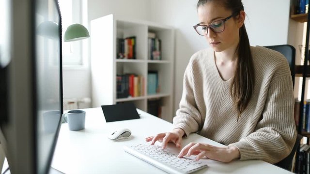 Young businesswoman working on computer at her home office